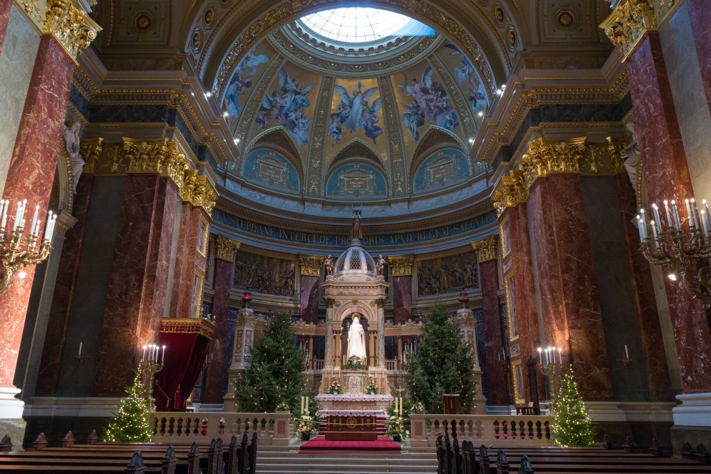 [Photo: Inside a cathedral in Budapest, Hungary, a piercing beam of light descends vertically through the oculus, striking the altar with absolute divine precision. Source: Myself]